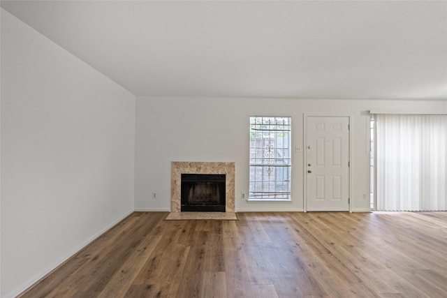 6500 Sands Point Dr Unit 107, Houston, TX 77074 - unfurnished living room with a premium fireplace, wood finished floors, and baseboards