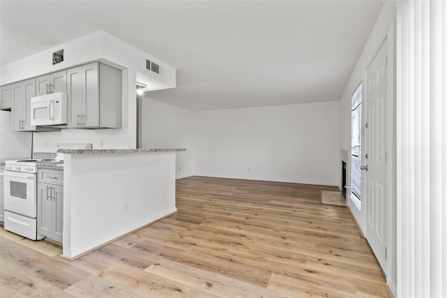 6500 Sands Point Dr Unit 107, Houston, TX 77074 - kitchen featuring white appliances, gray cabinetry, light wood-style flooring, and open floor plan