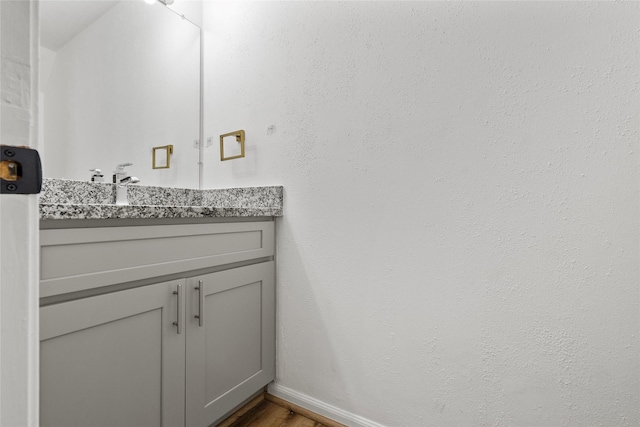 6500 Sands Point Dr Unit 107, Houston, TX 77074 - bathroom featuring vanity, wood finished floors, and baseboards