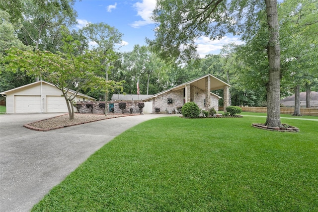 103 Whippoorwill Dr, Livingston, TX 77351 - mid-century home featuring driveway, a detached garage, view of scattered trees, brick siding, and an outdoor structure