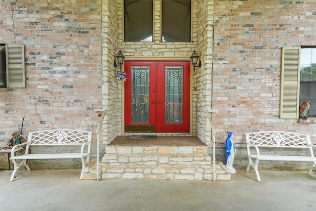 103 Whippoorwill Dr, Livingston, TX 77351 - view of exterior entry with french doors and brick siding