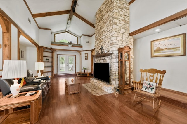 103 Whippoorwill Dr, Livingston, TX 77351 - living room with beam ceiling, wood finished floors, high vaulted ceiling, a fireplace, and french doors
