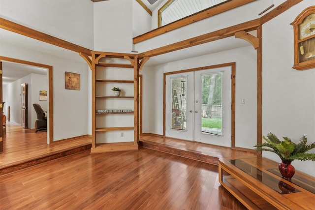 103 Whippoorwill Dr, Livingston, TX 77351 - living room with french doors, wood finished floors, an office area, and a towering ceiling