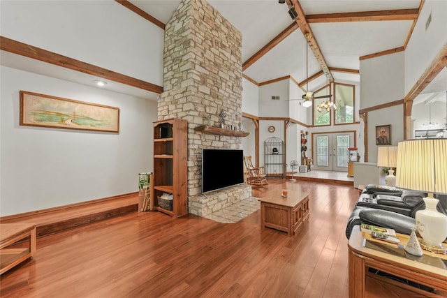 103 Whippoorwill Dr, Livingston, TX 77351 - living area with high vaulted ceiling, beam ceiling, a fireplace, wood finished floors, and a chandelier