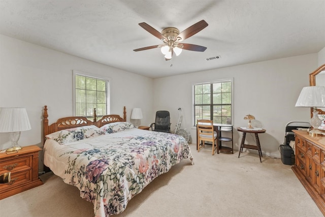 103 Whippoorwill Dr, Livingston, TX 77351 - bedroom with multiple windows, light carpet, and a ceiling fan