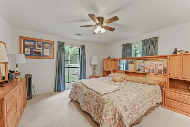103 Whippoorwill Dr, Livingston, TX 77351 - bedroom featuring light colored carpet, multiple windows, baseboards, and a ceiling fan