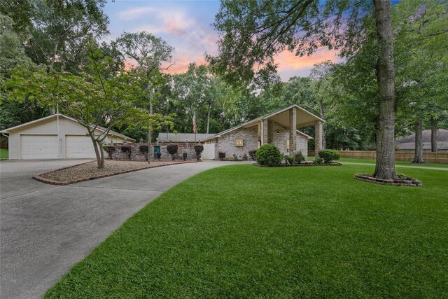 103 Whippoorwill Dr, Livingston, TX 77351 - mid-century inspired home featuring concrete driveway, a detached garage, and view of scattered trees