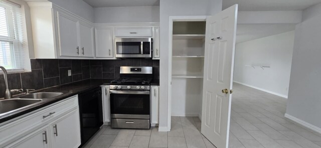 511 Minnesota St, South Houston, TX 77587 - kitchen with appliances with stainless steel finishes, tasteful backsplash, dark countertops, and white cabinets