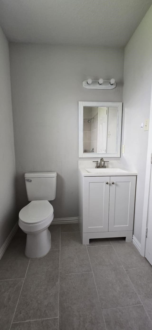 511 Minnesota St, South Houston, TX 77587 - bathroom with toilet, vanity, tile patterned floors, and baseboards