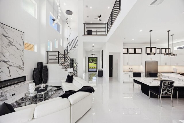 3379 Tampa St, Houston, TX 77021 - living area with light marble finish floors, a towering ceiling, stairway, and recessed lighting