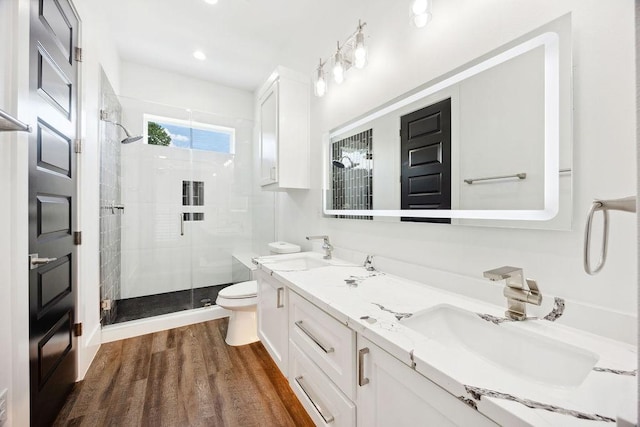 3379 Tampa St, Houston, TX 77021 - bathroom with a shower stall, toilet, double vanity, wood finished floors, and recessed lighting