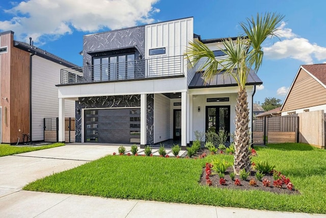 3379 Tampa St, Houston, TX 77021 - contemporary house with a balcony, french doors, an attached garage, concrete driveway, and a standing seam roof
