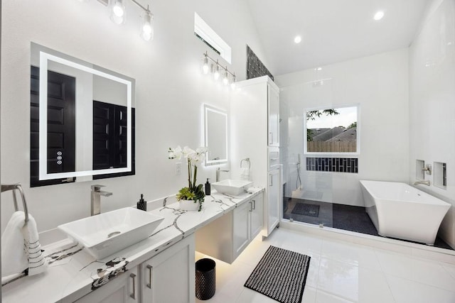3379 Tampa St, Houston, TX 77021 - bathroom with tiled shower, a soaking tub, double vanity, and tile patterned flooring