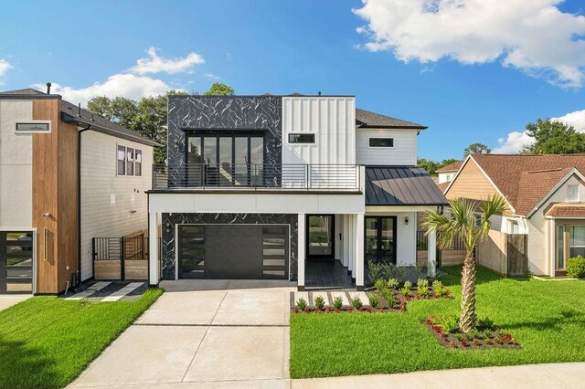 3379 Tampa St, Houston, TX 77021 - view of front facade with a balcony, concrete driveway, a standing seam roof, a front lawn, and a garage