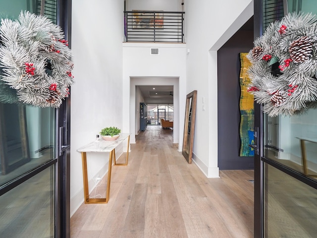407 Graceland St, Houston, TX 77009 - entrance foyer with light wood-style flooring, baseboards, and a towering ceiling