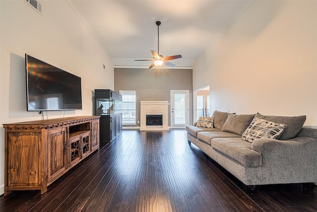 19426 Gladewater Dr, Tomball, TX 77375 - living area with dark wood-type flooring, a ceiling fan, ornamental molding, a brick fireplace, and baseboards