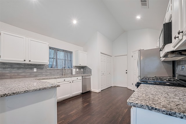 19426 Gladewater Dr, Tomball, TX 77375 - kitchen with stainless steel dishwasher, dark wood-type flooring, backsplash, white cabinetry, and gas range oven