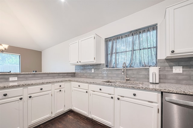 19426 Gladewater Dr, Tomball, TX 77375 - kitchen featuring dishwasher, a sink, white cabinetry, light stone countertops, and vaulted ceiling