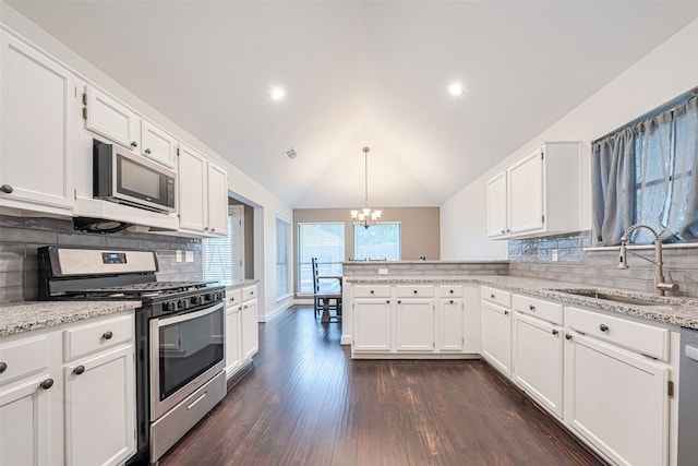 19426 Gladewater Dr, Tomball, TX 77375 - kitchen with stainless steel appliances, a sink, a chandelier, white cabinetry, and a peninsula