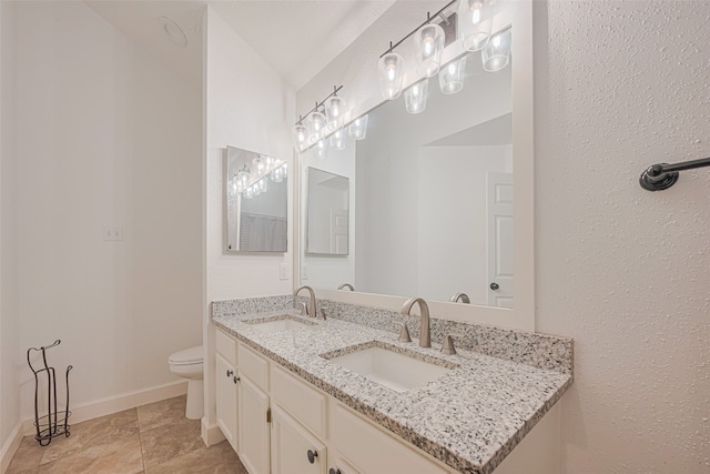 19426 Gladewater Dr, Tomball, TX 77375 - full bathroom with double vanity, toilet, and baseboards