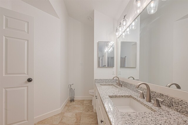 19426 Gladewater Dr, Tomball, TX 77375 - bathroom featuring toilet, double vanity, and baseboards