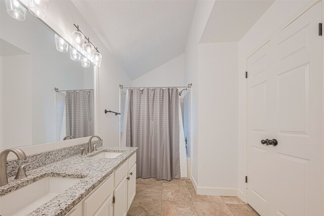19426 Gladewater Dr, Tomball, TX 77375 - full bathroom featuring double vanity, a shower with shower curtain, baseboards, and vaulted ceiling