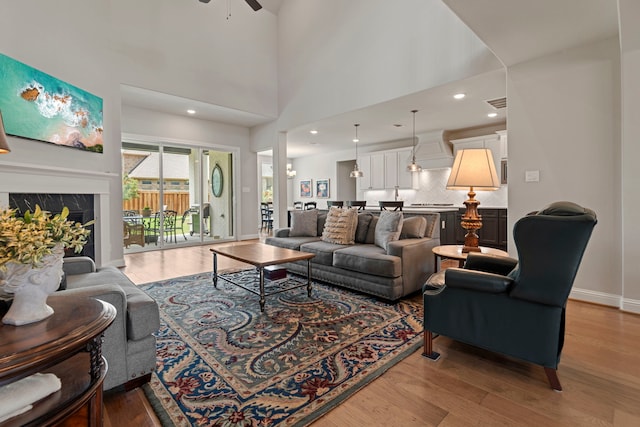 28228 Cedar Peak Dr, Spring, TX 77386 - living area featuring light wood-style floors, ceiling fan, baseboards, a premium fireplace, and recessed lighting