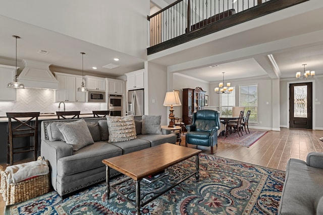 28228 Cedar Peak Dr, Spring, TX 77386 - living room with a chandelier, wood-type flooring, ornamental molding, baseboards, and recessed lighting