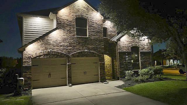 8106 Yarrow Dr, Cypress, TX 77433 - french country style house with driveway, a garage, and brick siding