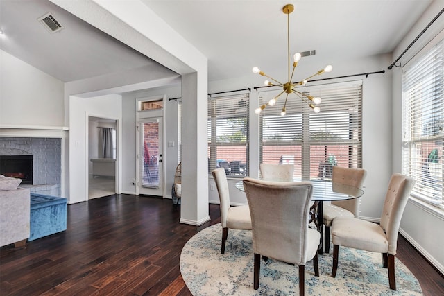 8106 Yarrow Dr, Cypress, TX 77433 - dining area with a chandelier, wood finished floors, baseboards, and a brick fireplace