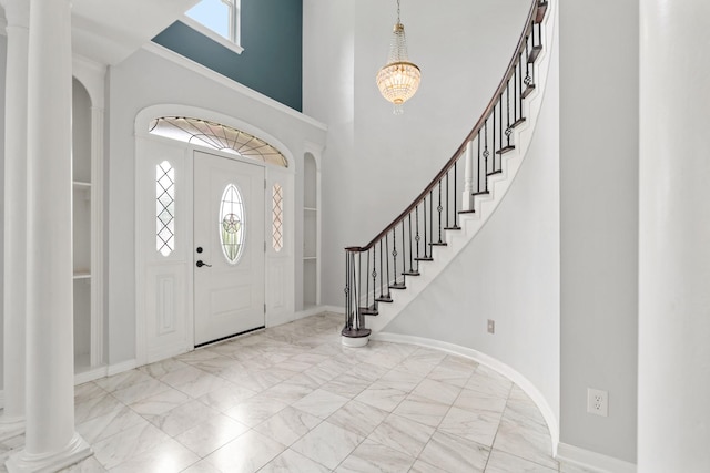 20003 Kingsland Blvd, Katy, TX 77450 - foyer with marble finish flooring, a towering ceiling, stairs, a chandelier, and baseboards