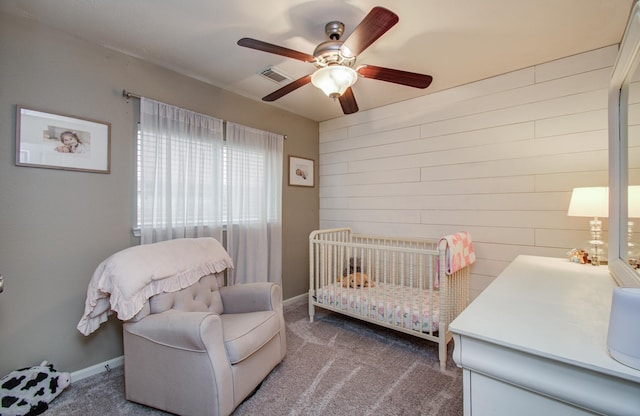 1918 Hollow Mist Ln, Pearland, TX 77581 - carpeted bedroom with wooden walls, a ceiling fan, and baseboards