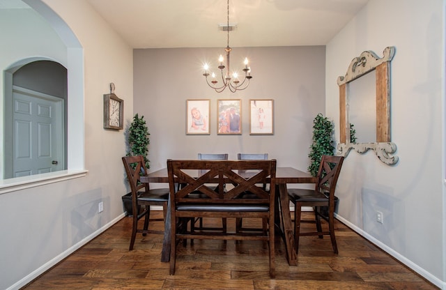 1918 Hollow Mist Ln, Pearland, TX 77581 - dining area with dark wood-style floors, a chandelier, arched walkways, and baseboards
