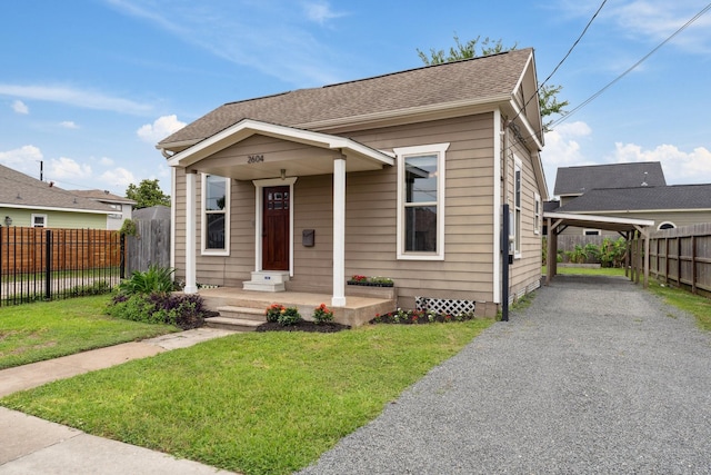2604 Cochran St, Houston, TX 77009 - bungalow featuring a carport, gravel driveway, and a shingled roof