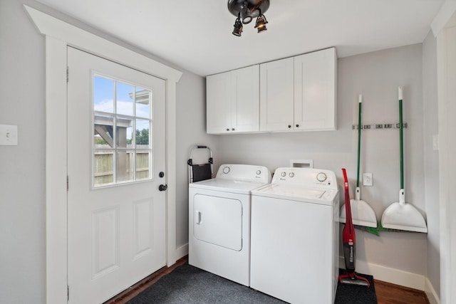 2604 Cochran St, Houston, TX 77009 - washroom featuring cabinet space, baseboards, washing machine and dryer, and dark wood-style flooring