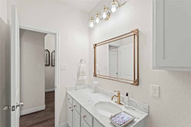 18731 Pilot Knolls Dr, Cypress, TX 77433 - bathroom with wood finished floors, vanity, and baseboards