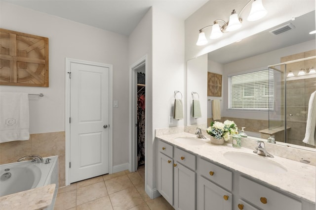 18731 Pilot Knolls Dr, Cypress, TX 77433 - bathroom featuring a stall shower, a bath, double vanity, tile patterned floors, and a walk in closet