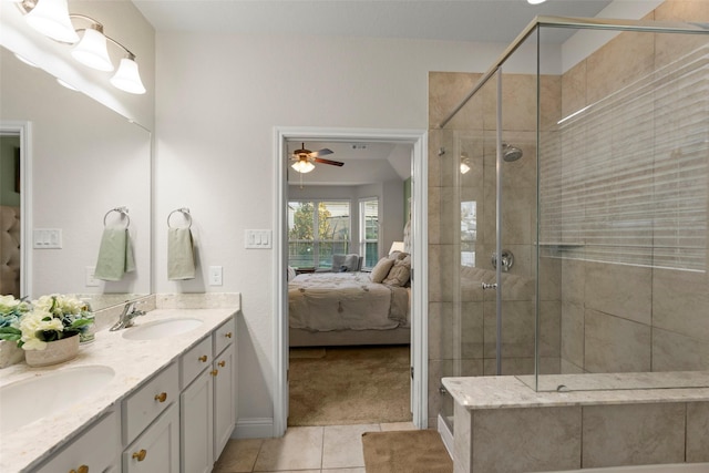 18731 Pilot Knolls Dr, Cypress, TX 77433 - ensuite bathroom with double vanity, tile patterned flooring, a shower stall, a ceiling fan, and baseboards