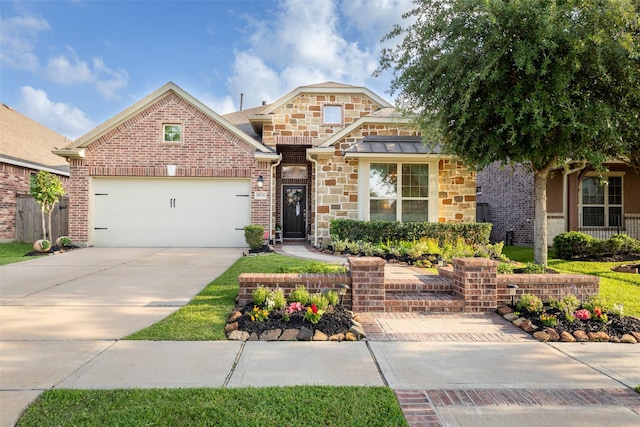 18731 Pilot Knolls Dr, Cypress, TX 77433 - view of front of house featuring an attached garage, concrete driveway, stone siding, and brick siding