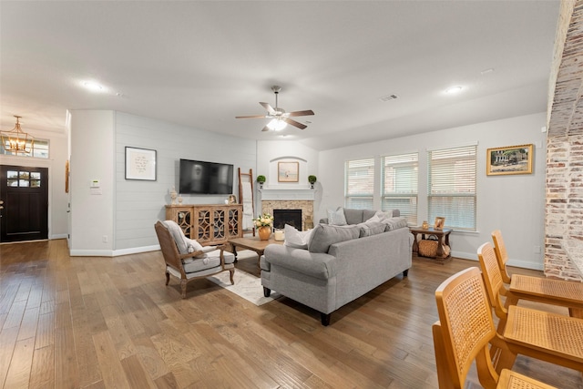 18731 Pilot Knolls Dr, Cypress, TX 77433 - living room featuring baseboards, a fireplace, a ceiling fan, and wood-type flooring