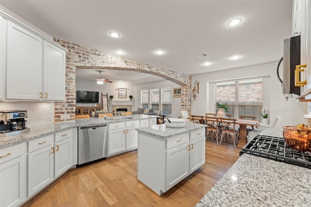 18731 Pilot Knolls Dr, Cypress, TX 77433 - kitchen featuring stainless steel appliances, ceiling fan, light wood-type flooring, open floor plan, and white cabinets