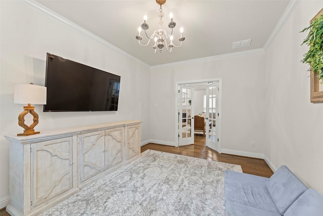 18731 Pilot Knolls Dr, Cypress, TX 77433 - living area featuring crown molding, a chandelier, french doors, wood finished floors, and baseboards