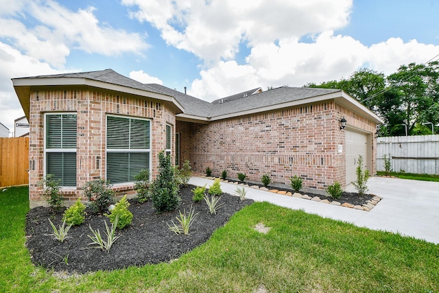 6718 Utah St, Houston, TX 77091 - view of front facade featuring brick siding, a garage, driveway, and roof with shingles