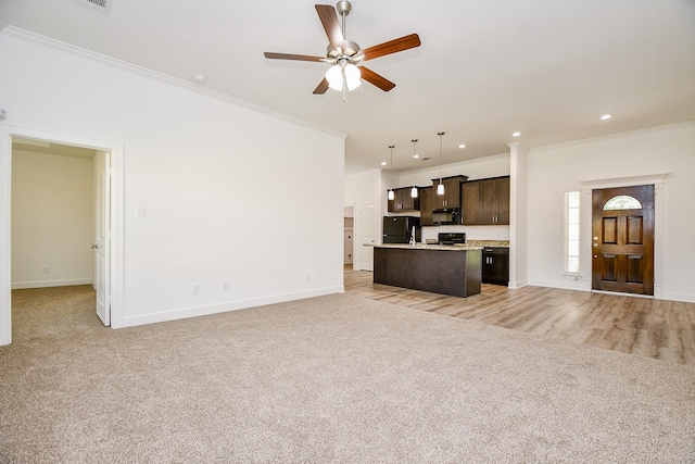 6718 Utah St, Houston, TX 77091 - unfurnished living room with light carpet, crown molding, ceiling fan, baseboards, and recessed lighting