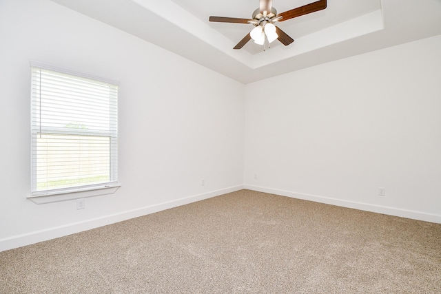 6718 Utah St, Houston, TX 77091 - unfurnished room with healthy amount of natural light, carpet flooring, a raised ceiling, and a ceiling fan