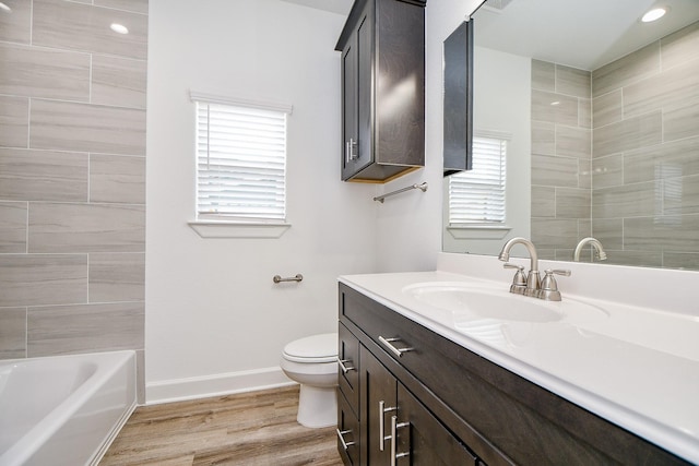 6718 Utah St, Houston, TX 77091 - bathroom with toilet, vanity, baseboards, wood finished floors, and shower / bathtub combination