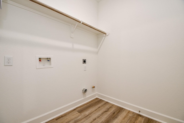 6718 Utah St, Houston, TX 77091 - laundry room with light wood finished floors, washer hookup, electric dryer hookup, hookup for a gas dryer, and baseboards