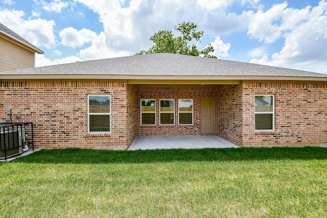 6718 Utah St, Houston, TX 77091 - rear view of property featuring brick siding, a patio area, a lawn, and roof with shingles