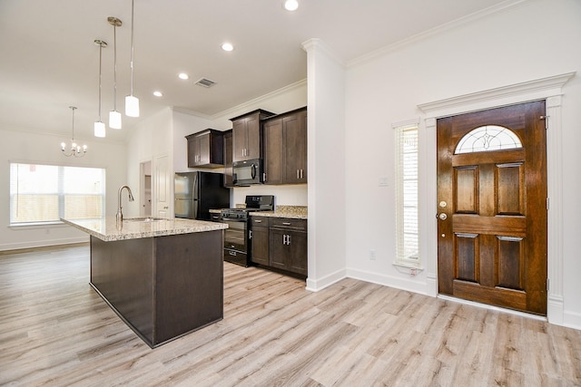 6718 Utah St, Houston, TX 77091 - kitchen with black appliances, dark brown cabinetry, a sink, light wood-style floors, and crown molding
