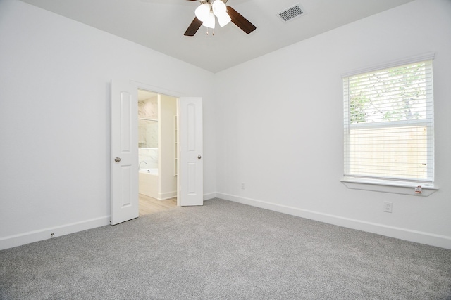 6727 Utah St, Houston, TX 77091 - unfurnished bedroom with light carpet, baseboards, ensuite bathroom, and ceiling fan
